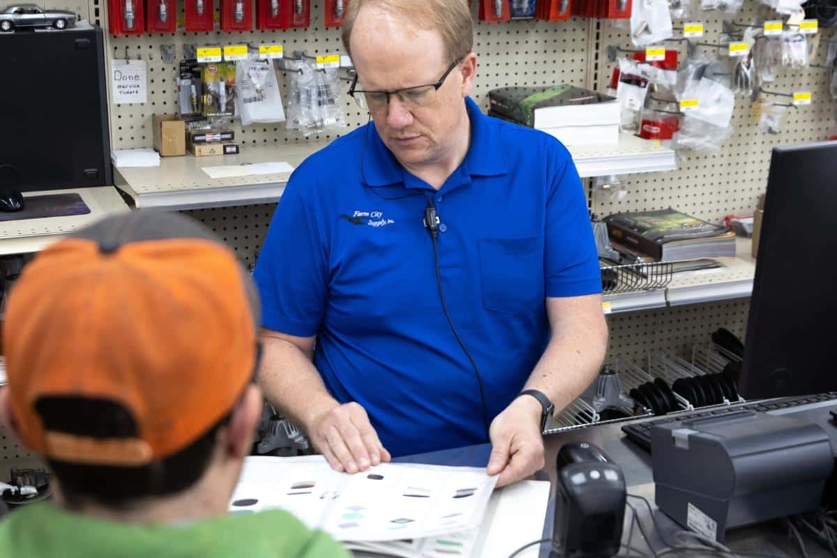 Customer stocking up on farm supplies at the front counter