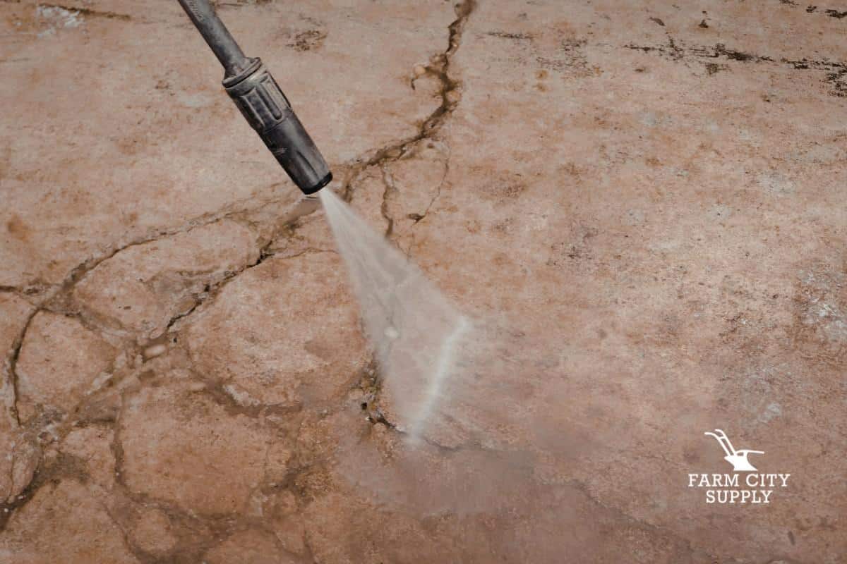 Pressure washing a concrete surface to remove dirt and grime for spring cleaning